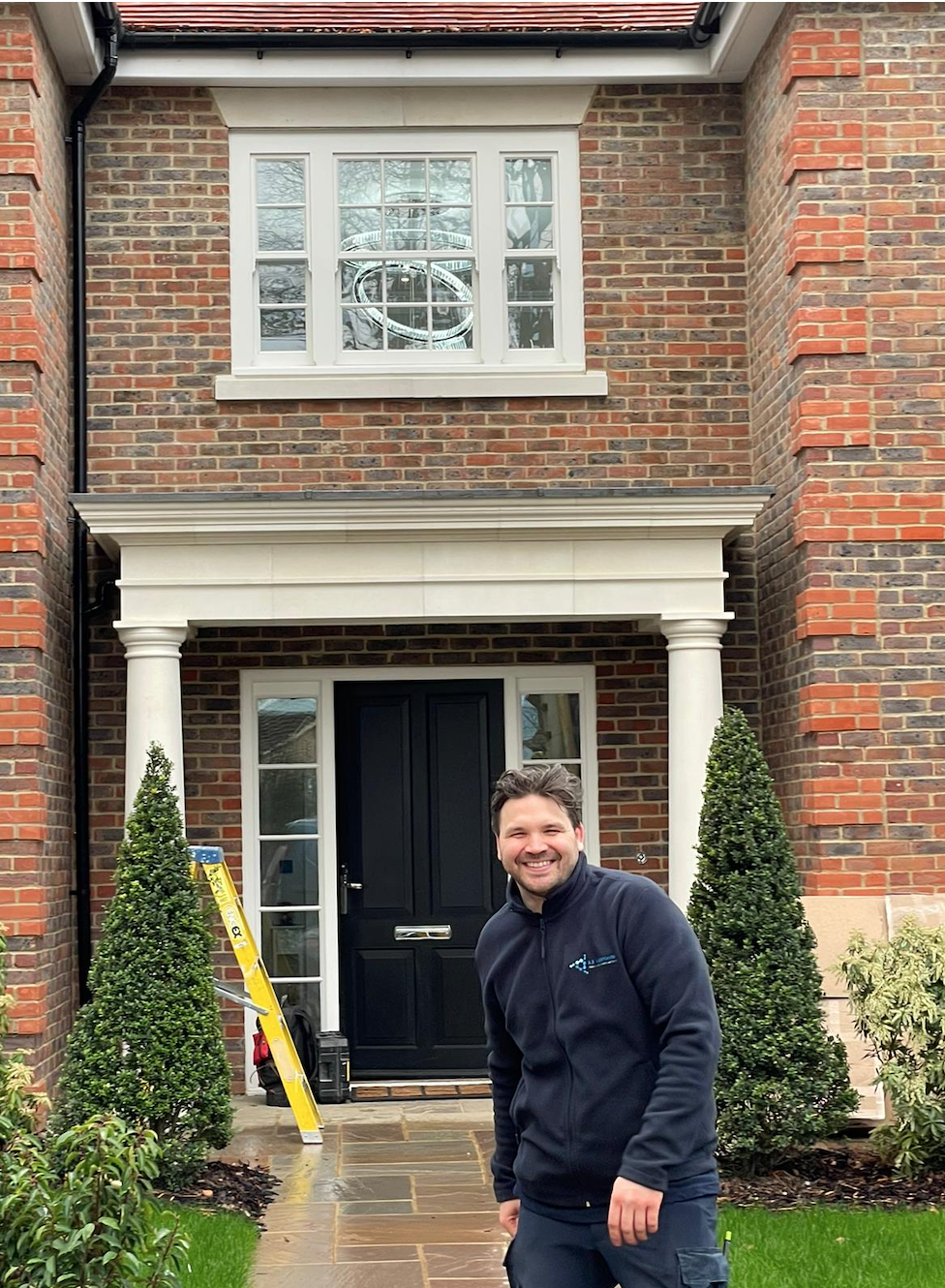 RB Response electrician outside the front door of a newly finished house