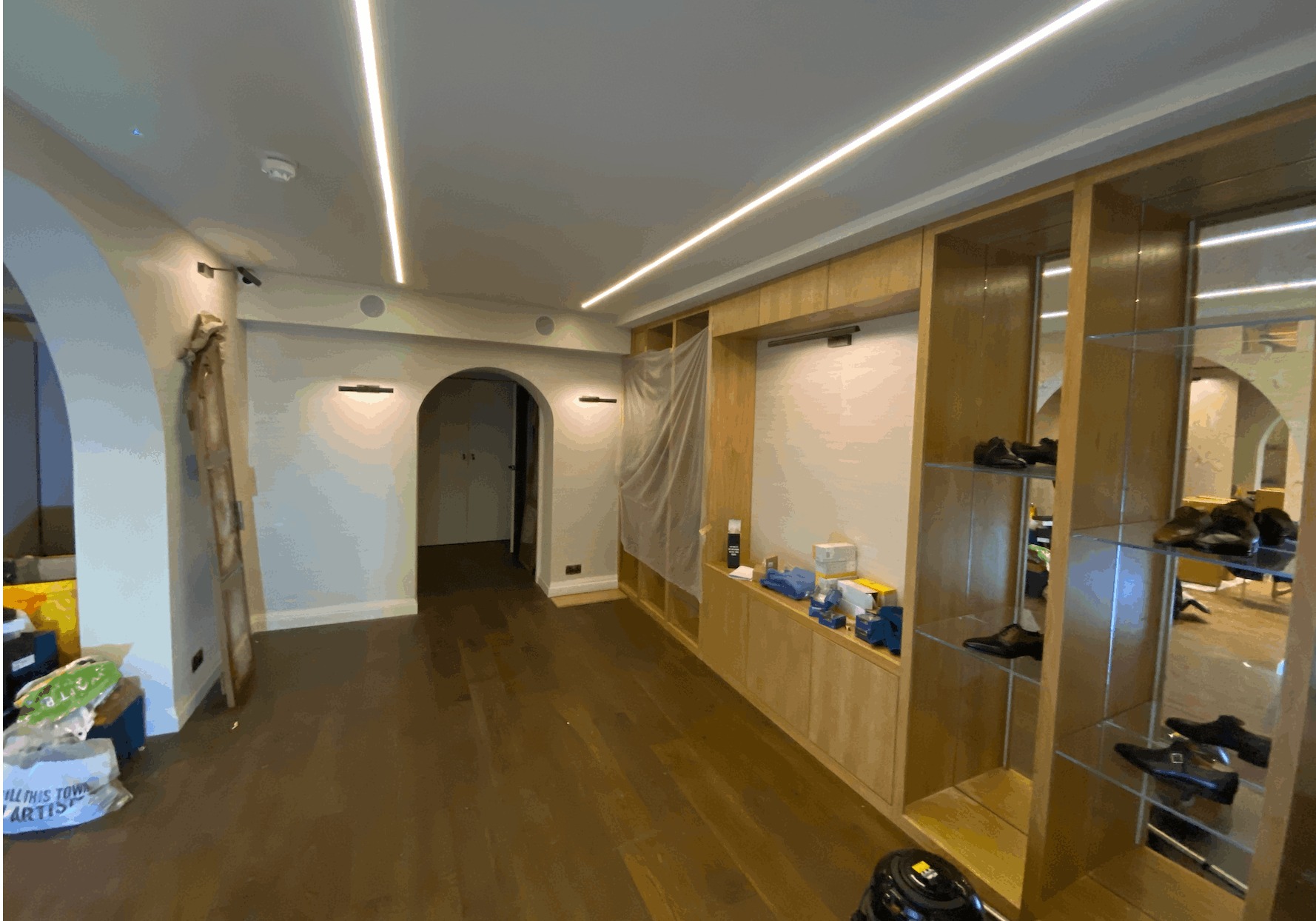 Retail interior with linear LED ceiling lights and lit timber shelving